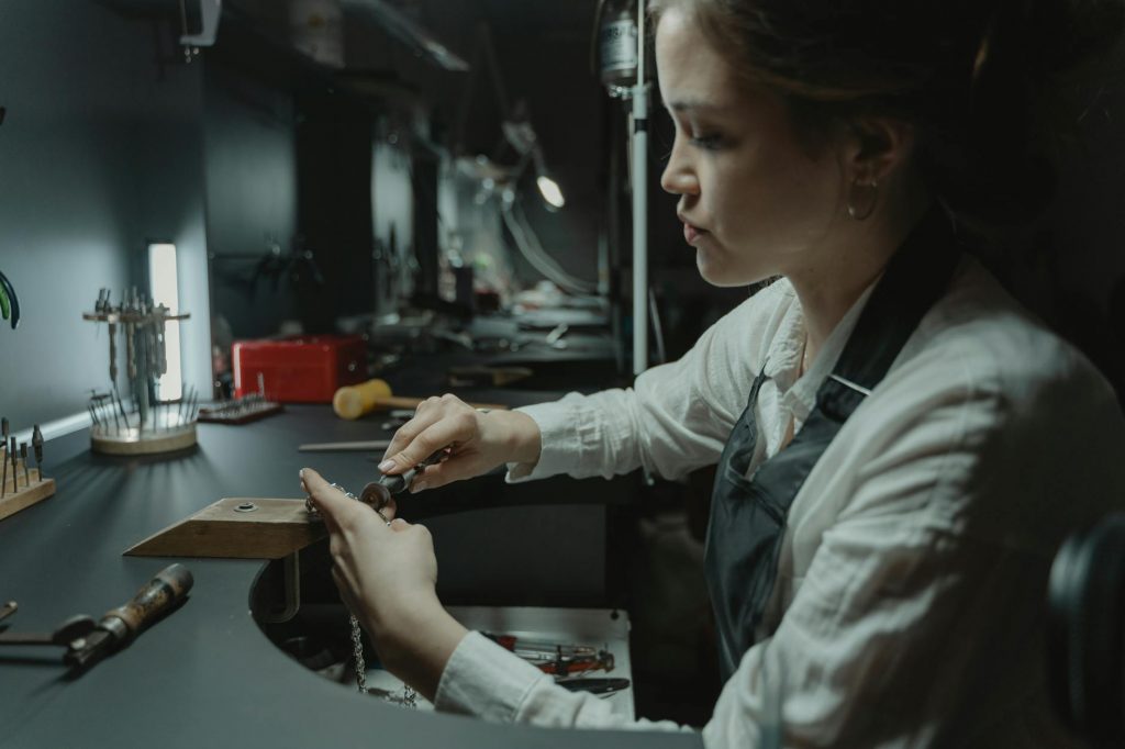 a jeweler using a rotary tool